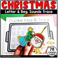 A hand holding a Christmas-themed cookie card with a Santa Claus design, part of a letter and begining sound tracing activity set.