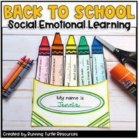 A craft activity called 'Back to School Social-Emotional Learning' with various crayon colors and templates for writing, along with a scissor and a clip, on a table.